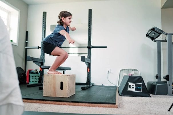 girl jumping on box